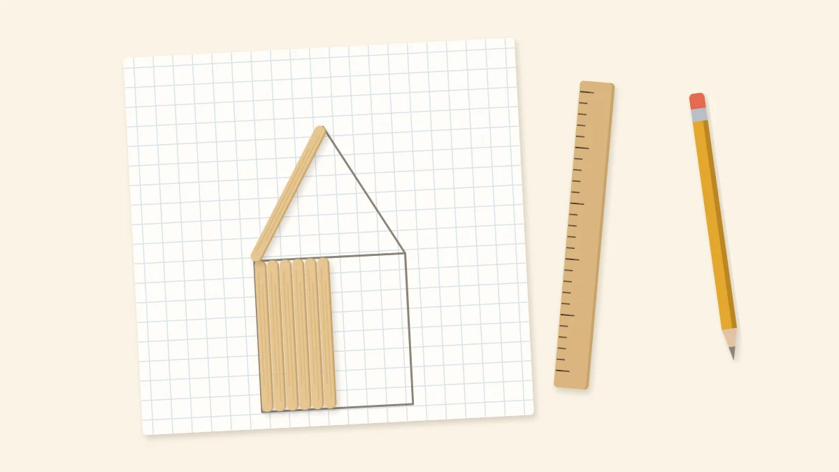 Grid paper with a pencil house outline half covered by craft sticks, with a pencil and ruler
