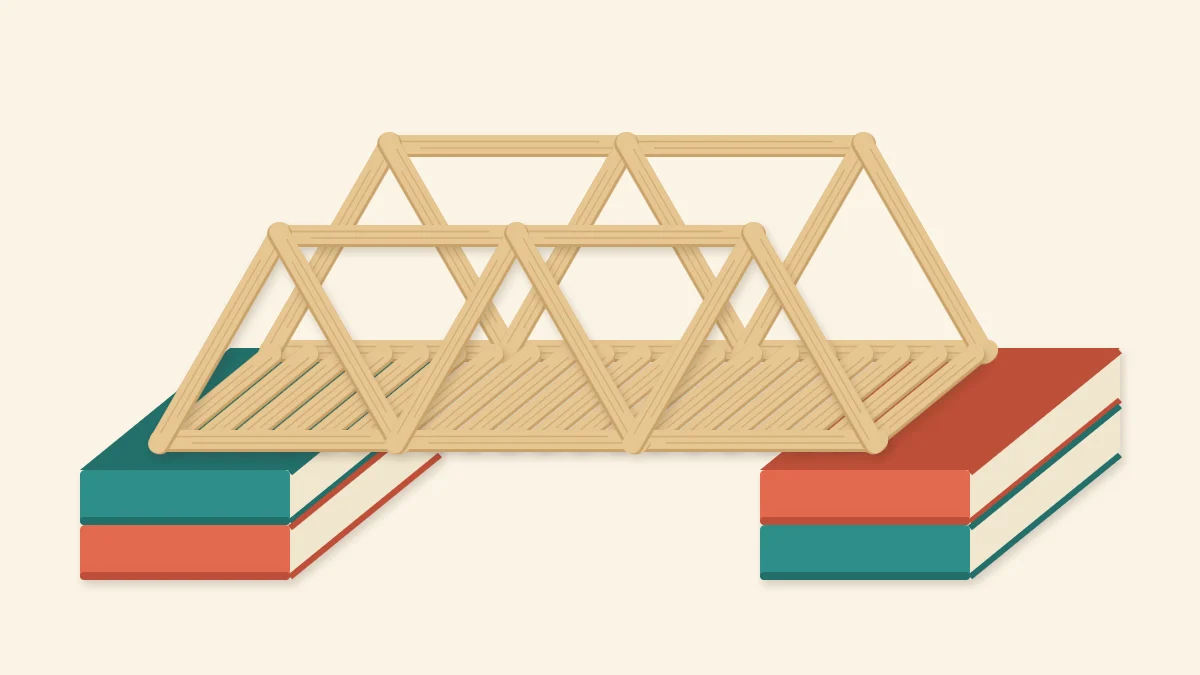 Popsicle stick truss bridge model with zigzag triangles spanning between two stacks of books